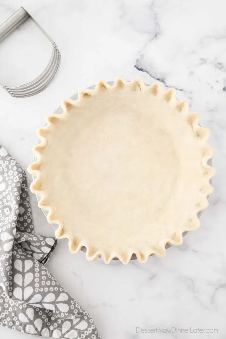 All butter pie crust fitted in pan with crimped edges.