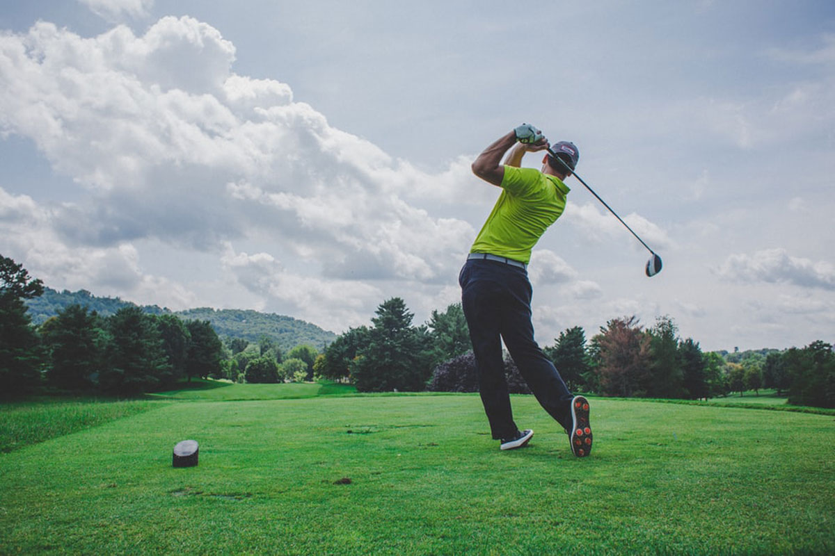 Golfer swings on Sydney course.