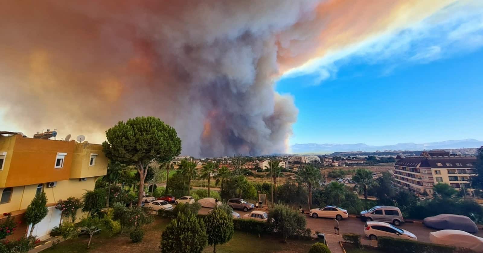 wildfire seen in the distance of a city