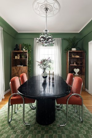 green dining room with vintage furniture