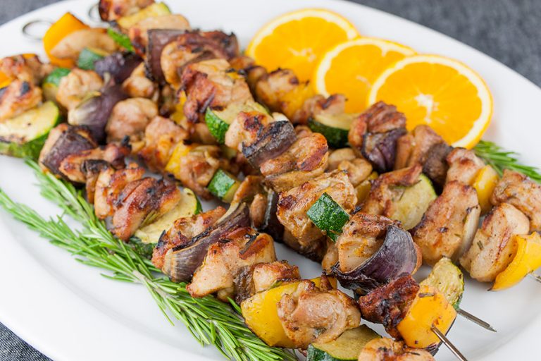 Orange Rosemary Chicken Kebabs on a white platter.