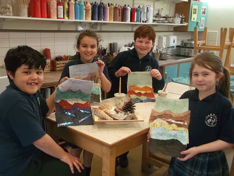 Pupils (l-r) James, Lily, Christina, and Leo with their artworks