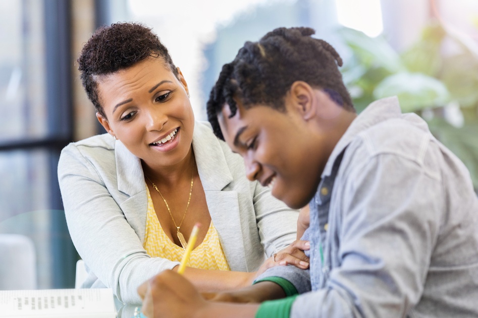 Woman helping teen with homework