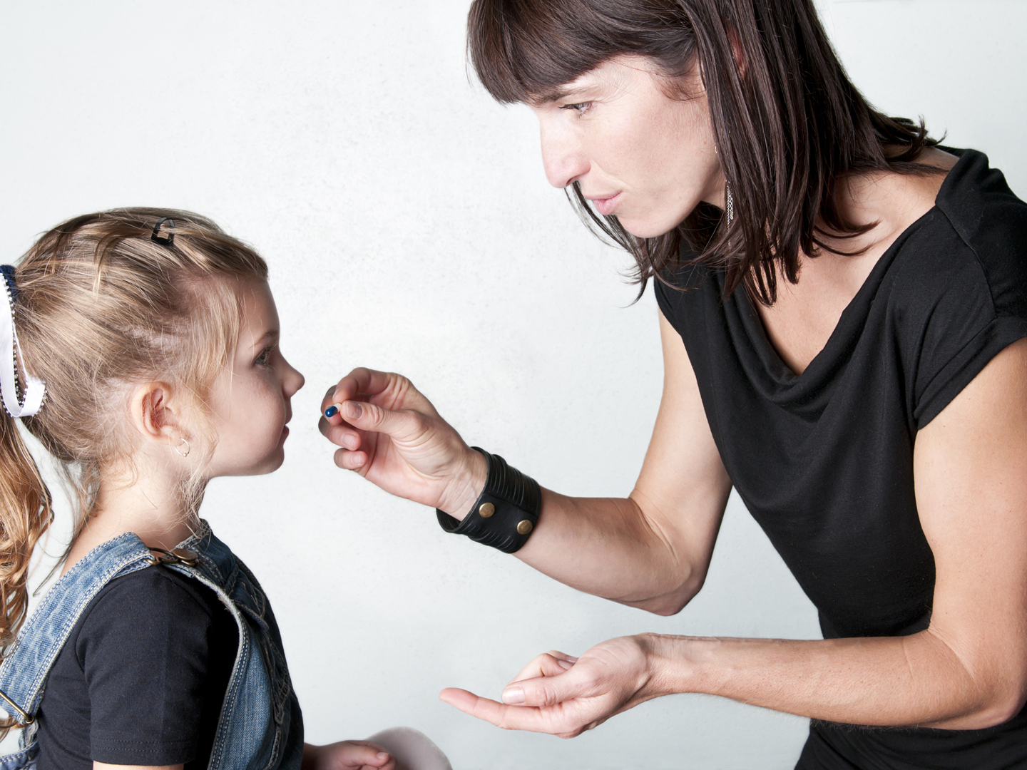 Mom giving medicine to little girl &#8211; I