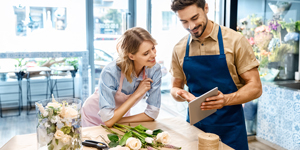 Two commercial business owners checking online resources on tablet