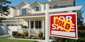 realtor for sale sign outside a home with good curb appeal