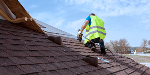 Roofer installing shingles after a roof tearoff