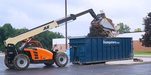 excavator loading commingled debris in a dumpsters.com dumpster