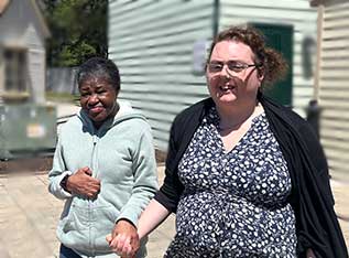 Two women holding hands