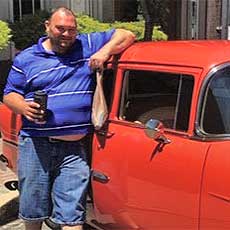 Man with car at car show