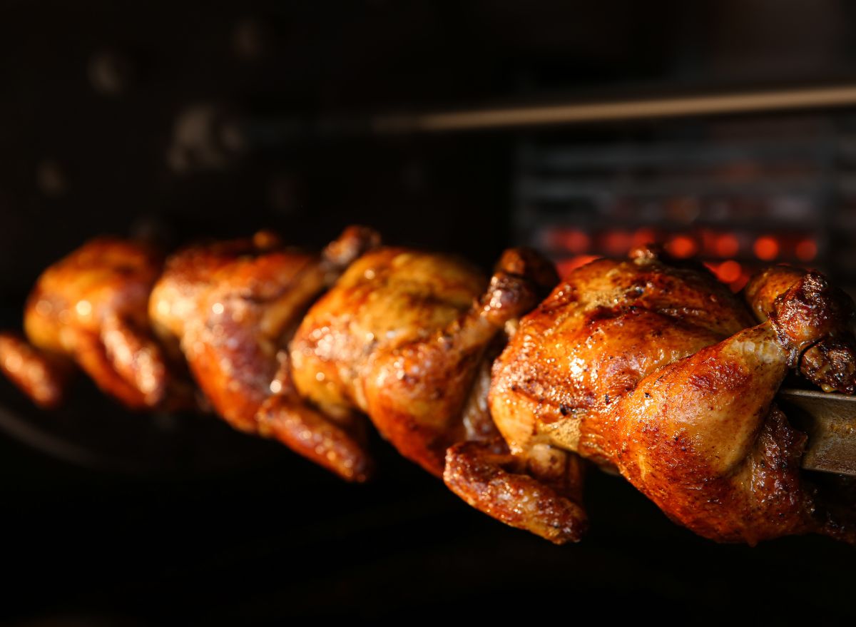 Rotisserie chickens on skewer in oven