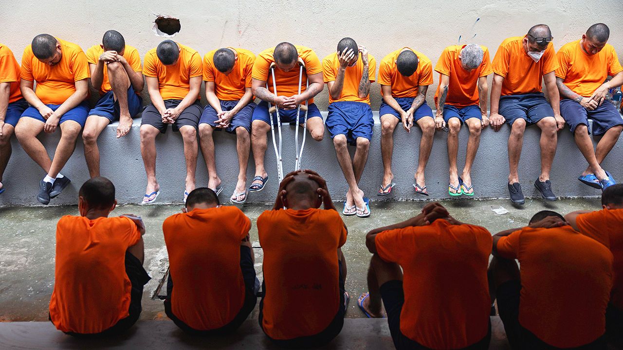 Prisoners at Ecuador's largest prison, the Litoral Penitentiary, sit outside their cell block.