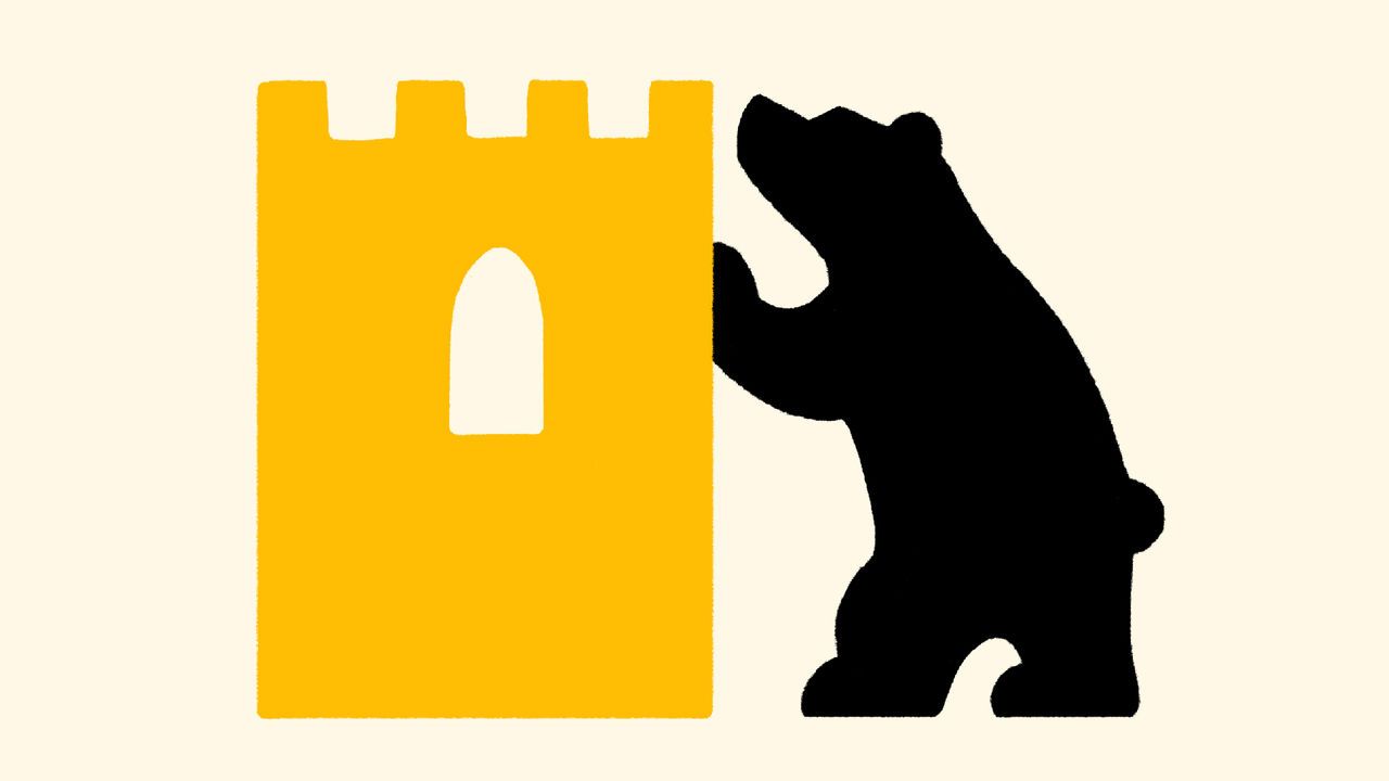 A bear next to a castle.