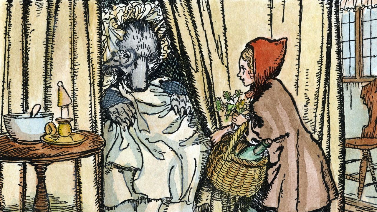 Little Red Riding Hood with the wolf, disguised as her grandmother. Illustration by Arthur Rackham (1867-1939), c1909.