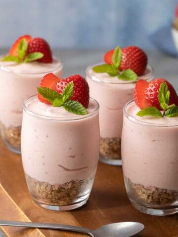 Four Healthier Strawberry Cheesecake Shots on a table