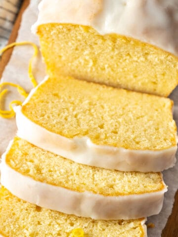 Slices of cake on a wooden cutting board.