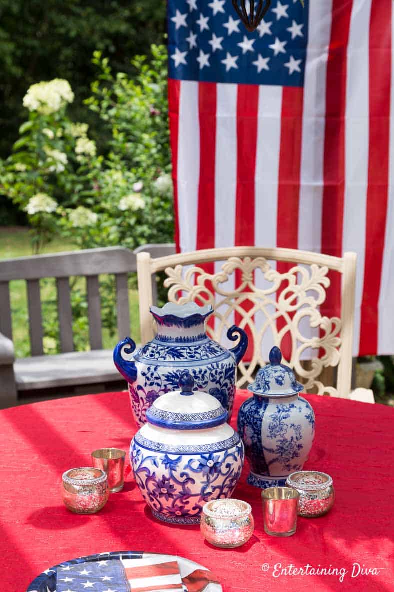 Blue and white vases with a red tablecloth on an outdoor table