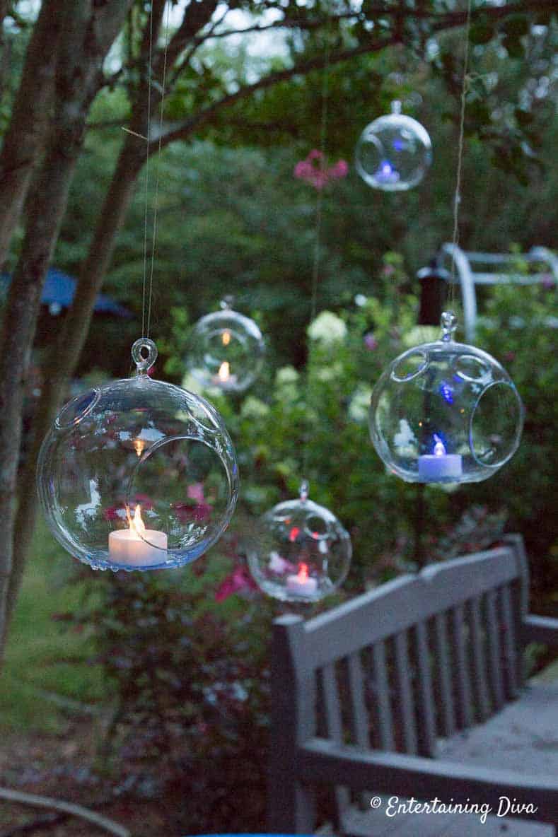 Red, white and blue flameless tealights hanging from tree