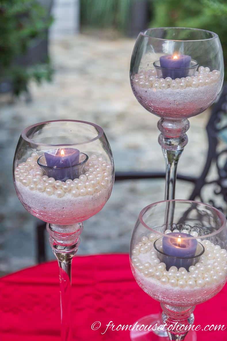 White and blue candleholders with a red table cloth for July 4th decorations