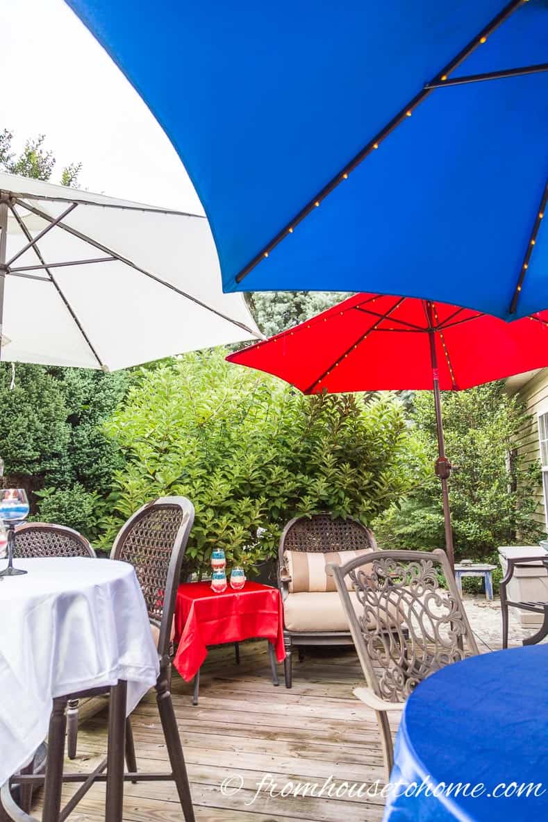 Red, white and blue umbrellas with lights on a deck