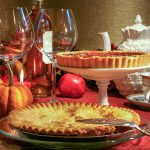 two pieces on a table with wine glasses