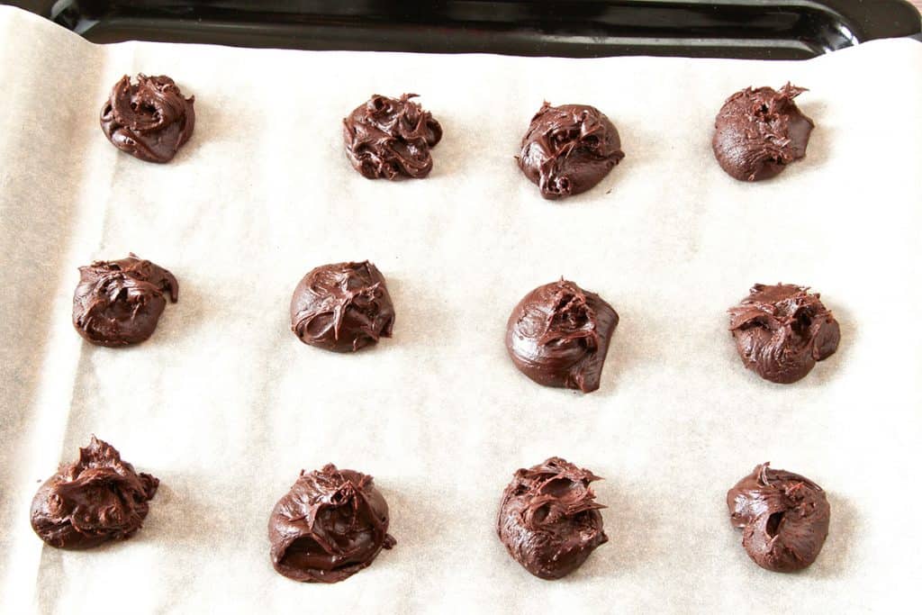 scoops of cookie batter placed on a baking sheet