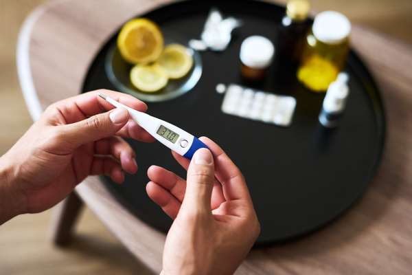 A Person Is Holding an Electronic Thermometer