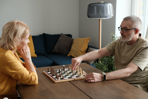 A Man Playing Chess with His Wife