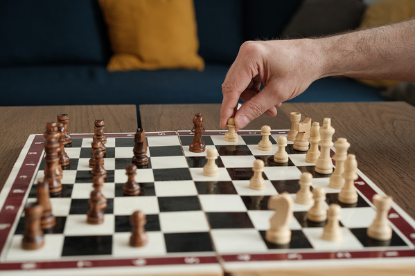 An Elderly Man Playing Chess with His Wife