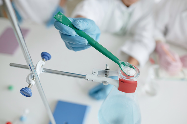 A Person Wearing Blue Gloves Is Holding a Toothbrush