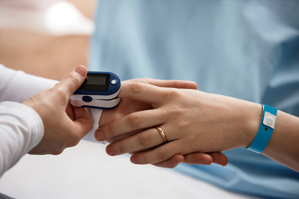 A Person Measuring the Blood Pressure of Another Person\'S Wrist