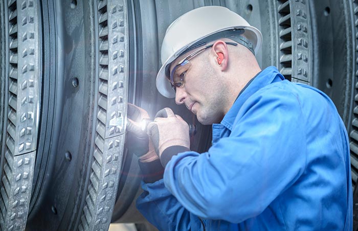 Technician inspecting machinery