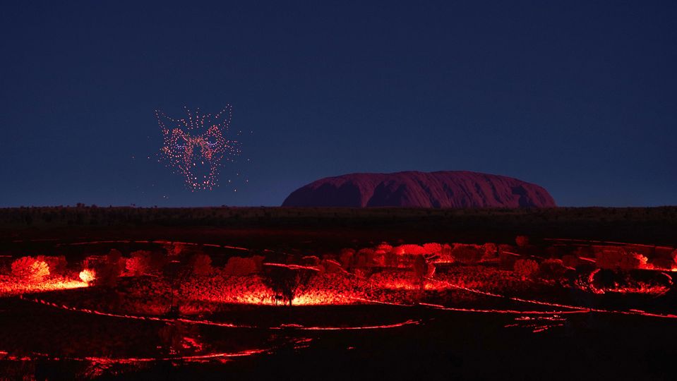 A shape-shifting spirit floating in the sky before Uluru.