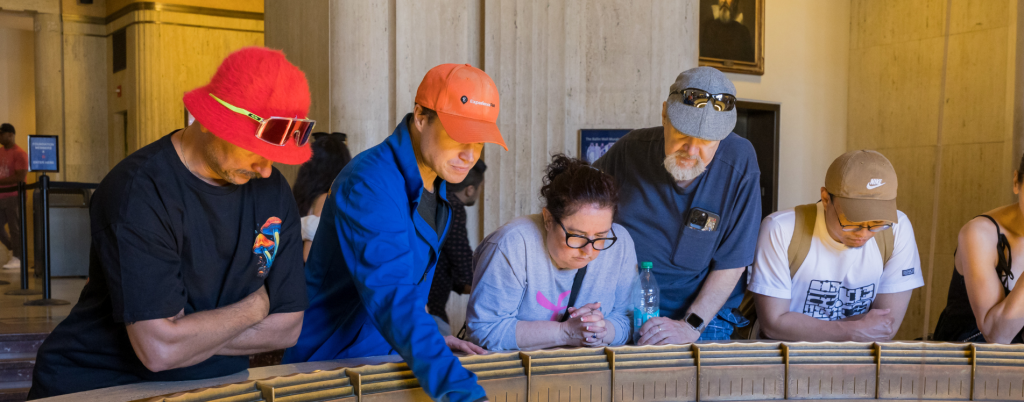 Tour guide and guests looking below inside the Griffith Observatory