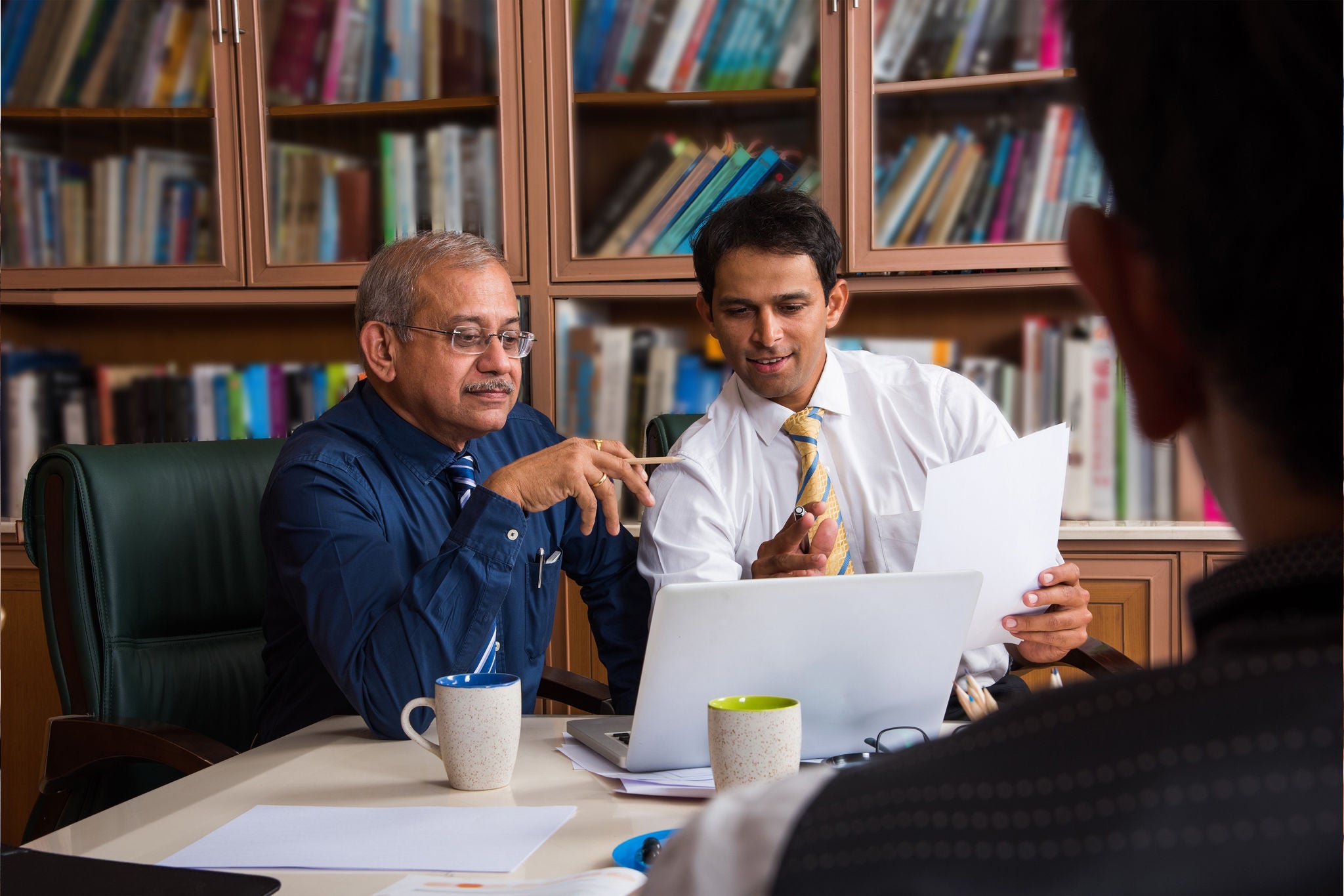 Two business men looking at computer