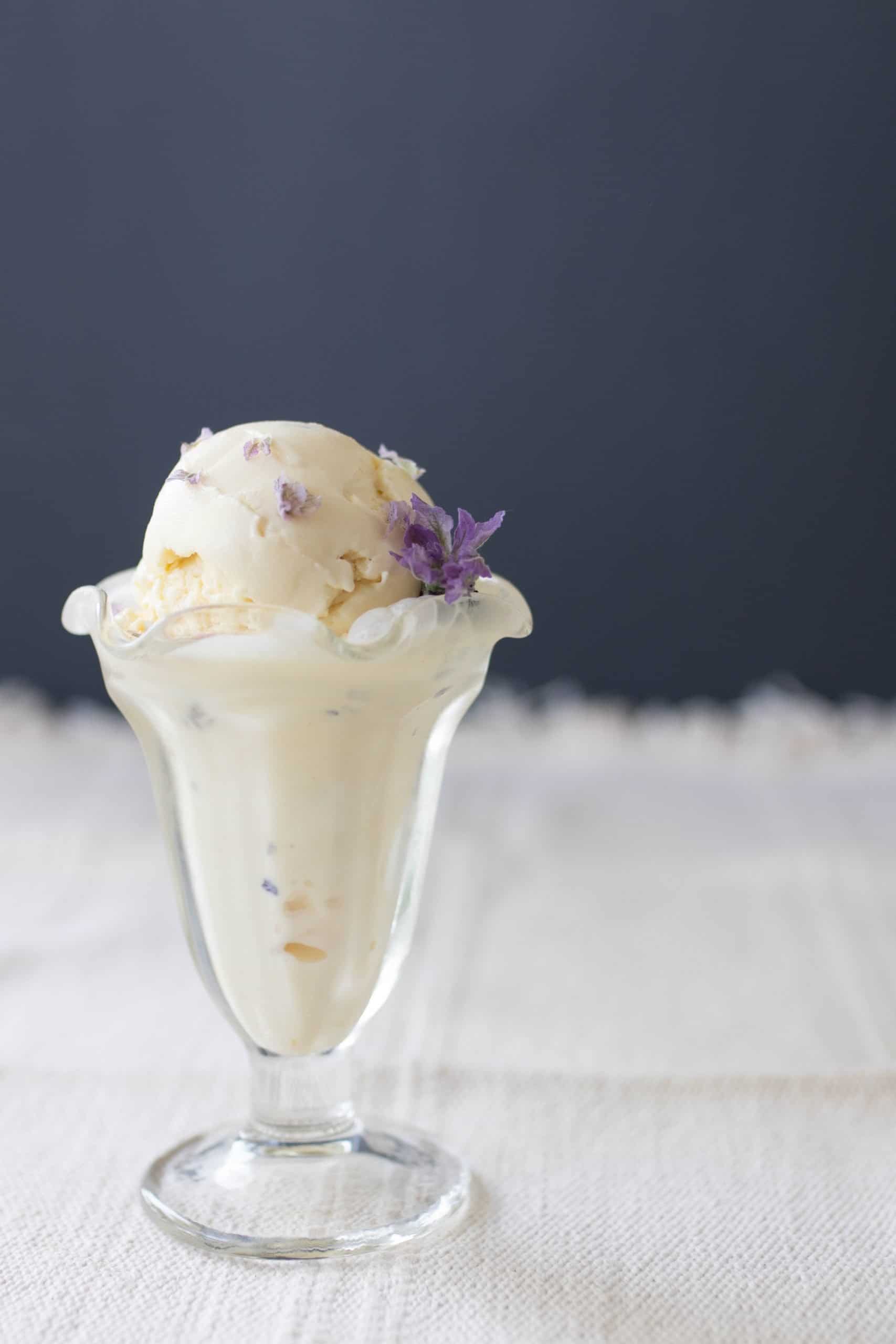 lavender ice cream in a glass Sunday cup with a Lavender flower in the ice cream.