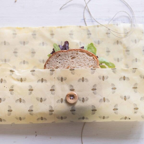 sandwich placed in a beeswax wraps with a button and string