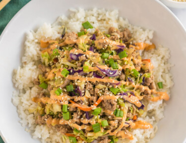 Egg Roll Bowl topped with spicy mayo and sesame seeds