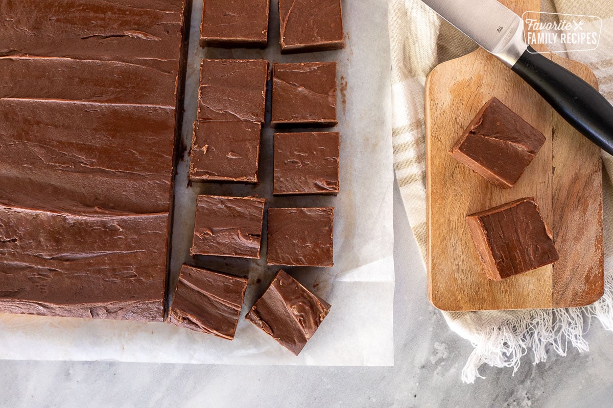 Cutting up block of See's Fudge with a knife.