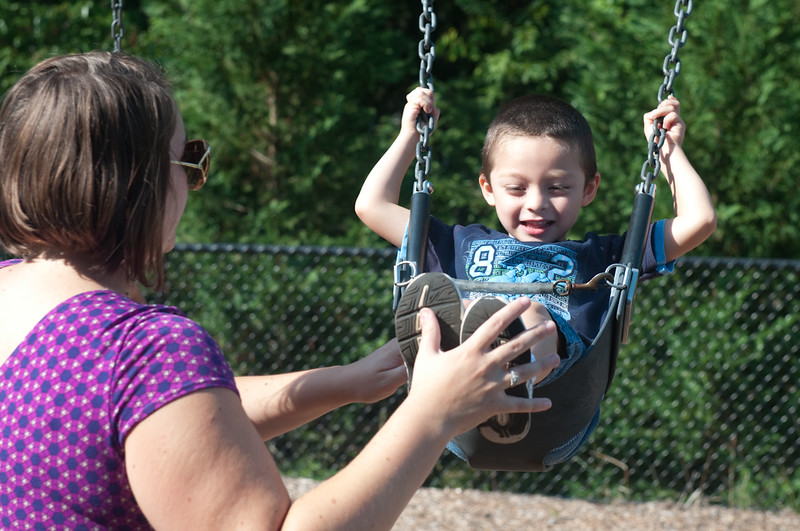 Photo of student being pushed in a swing