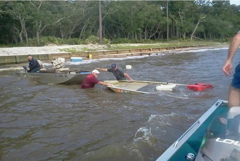 One Jon boat hauling another sunken Jon boat