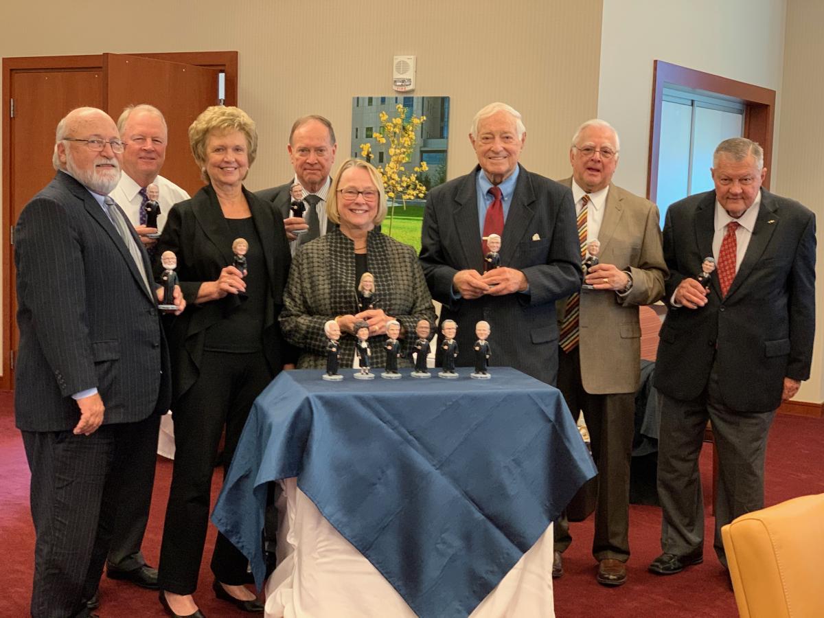 The Middle District of Florida Senior District Judges pose with their respective personalized bobblehead figures.