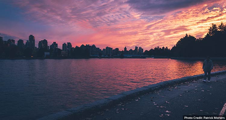 A purple-red sunset behind a dark skyline