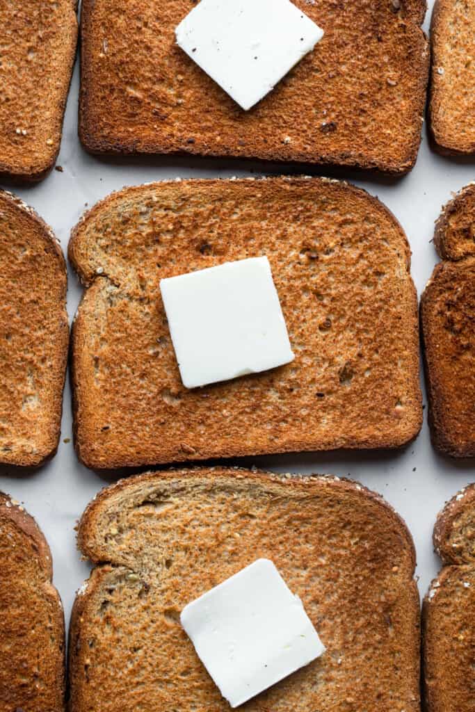 butter on a bunch of slices of Air Fryer Toast