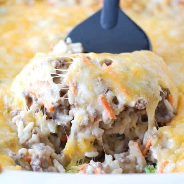 A spatula lifting ground beef and rice casserole.