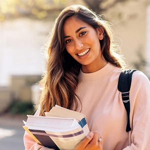 Girl with books looking at camera