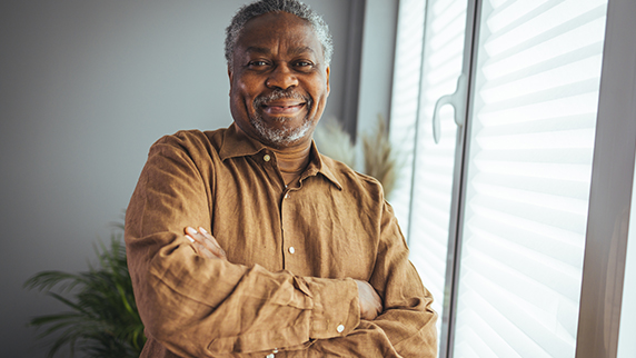 Man with arms crossed looking at camera