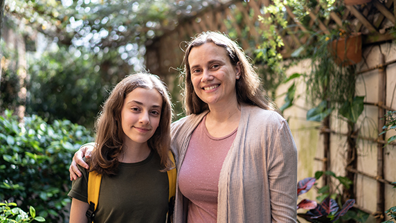 Mother with arm around daughter