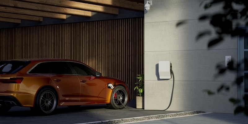 Modern generic electric vehicle EV hybrid car is being charged from a wallbox