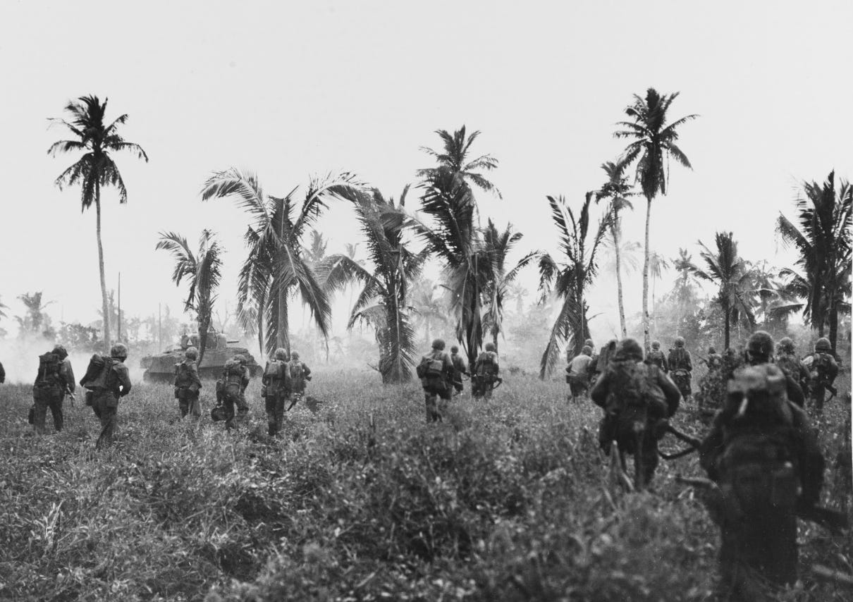 Marines advancing on Guam, in company with an M-4 Sherman tank, July-August 1944.